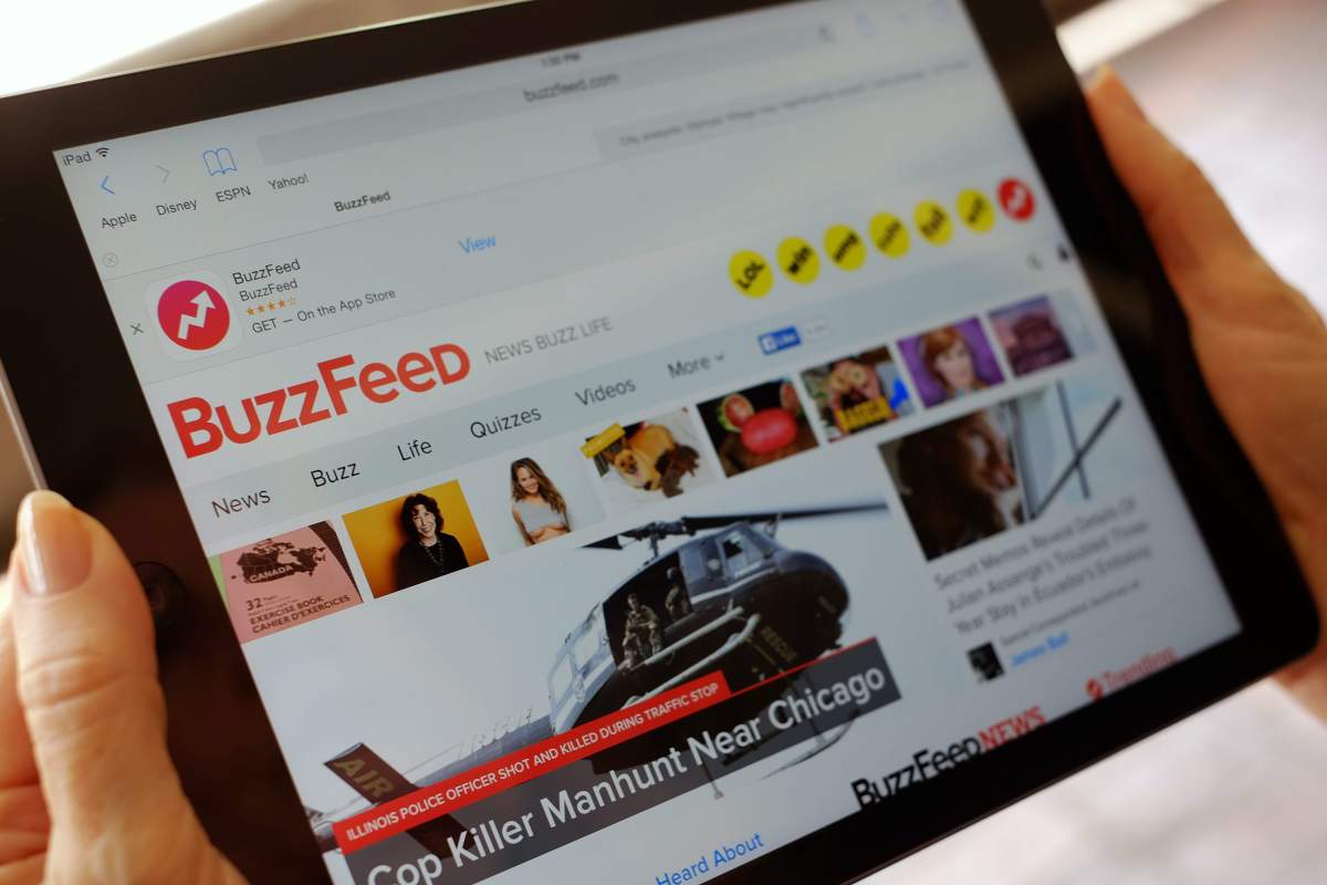 The BuzzFeed website is displayed on an iPad held by an Associated Press staffer in Los Angeles, on Tuesday, Sept. 1, 2015.