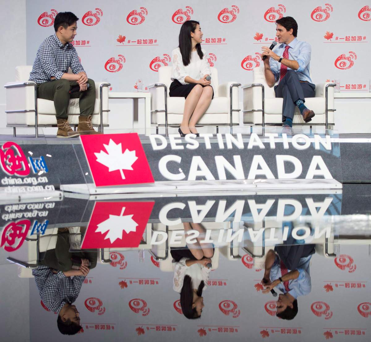 Canadian Prime Minister Justin Trudeau talks with Yani (Wanderer), who is a teacher and influencer on social media as they take part in an event at Sina Weibo Headquarters in Beijing, China, on Monday, Dec. 4, 2017, to promote Canada-China tourism.