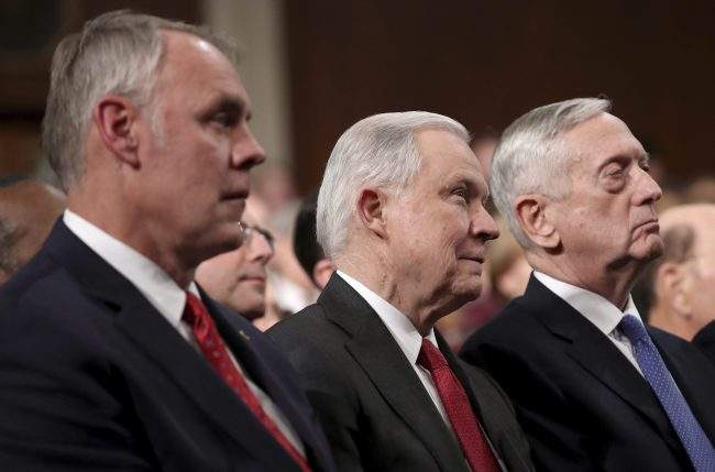 In this Jan. 30, 2018 file photo, Secretary of the Interior Ryan Zinke, Attorney General Jeff Sessions and Secretary of Defense Jim Mattis watch Donald Trump deliver the State of the Union address in the chamber of the U.S. House of Representatives in Washington.