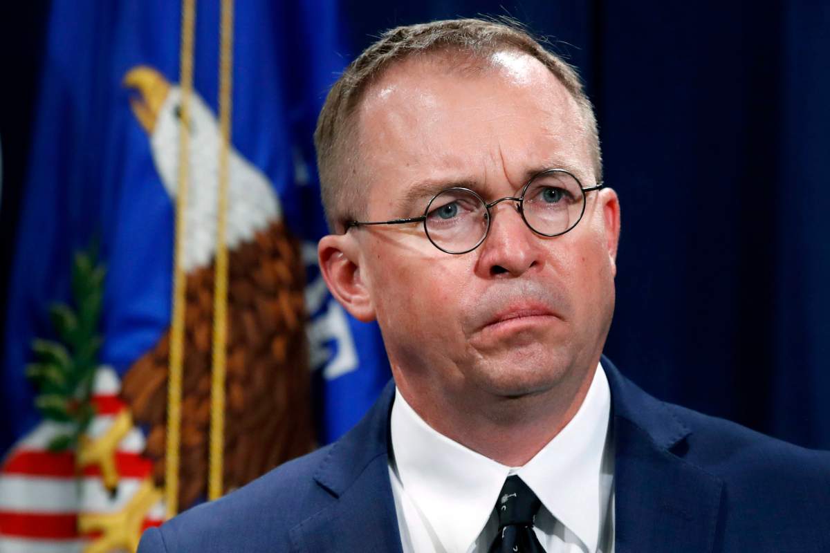 In this July 11, 2018, file photo Mick Mulvaney, acting director of the Consumer Financial Protection Bureau (CFPB), and Director of the Office of Management, listens during a news conference at the Department of Justice in Washington.
