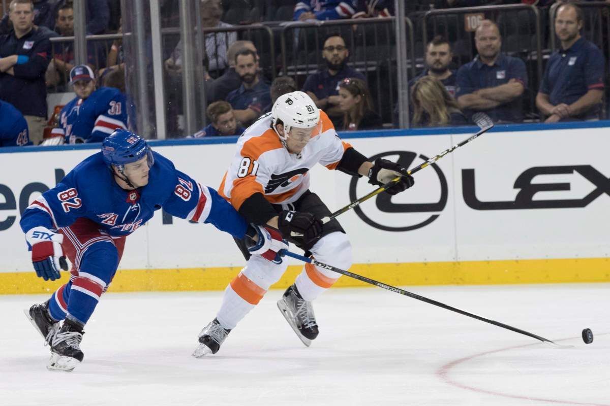 New York Rangers defenceman Joey Keane (82) and Philadelphia Flyers left wing Carsen Twarynski (81) battle for the puck during the first period of a preseason NHL hockey game, Wednesday, Sept. 19, 2018, at Madison Square Garden in New York. 