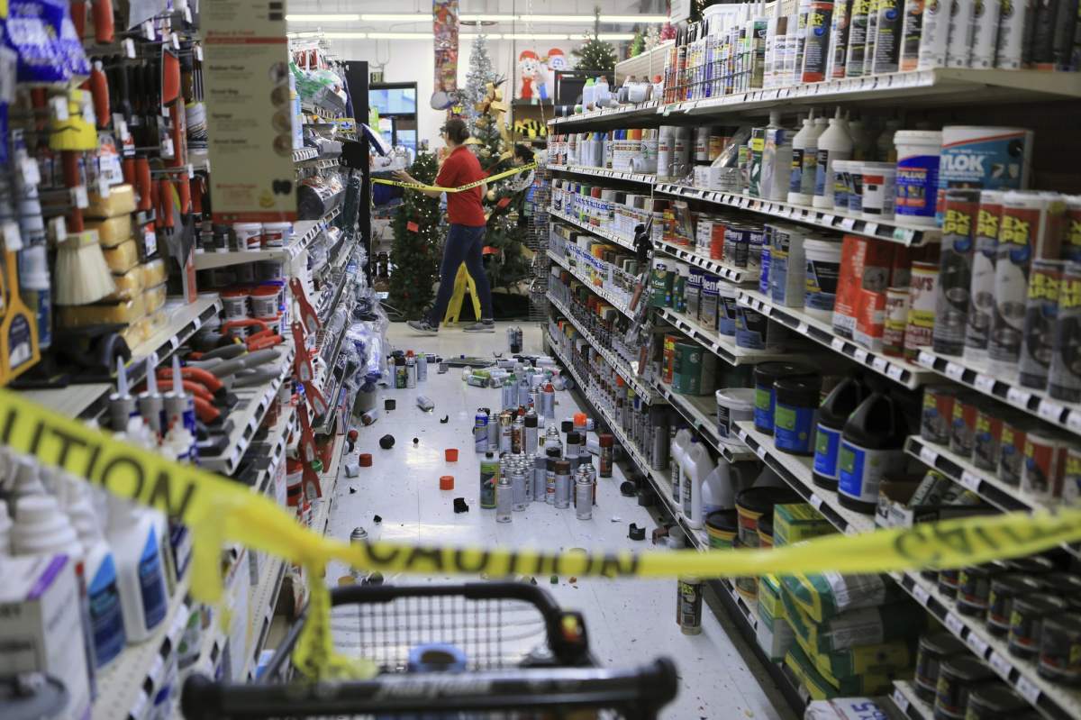 An employee walks past a damaged aisle at Anchorage True Value hardware store after an earthquake, Friday morning, Nov. 30, 2018, in Anchorage, Alaska.