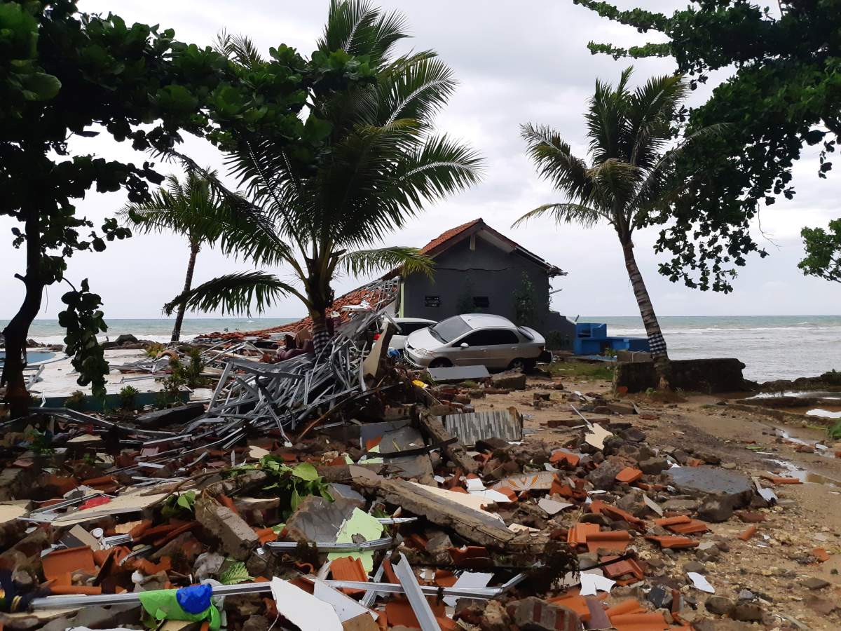 A car is seen among ruins after a tsunami hit Carita beach in Pandeglang, Banten province, Indonesia, Dec. 23, 2018.