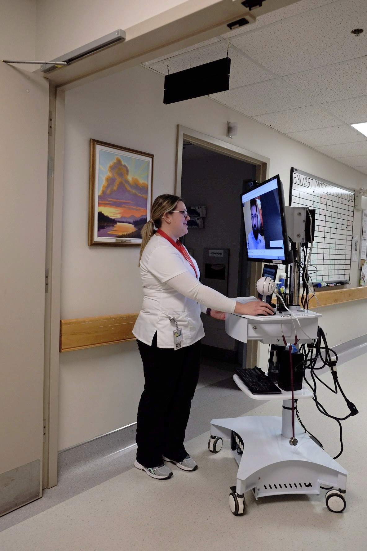 A nurse uses a TV cart with a doctor on a secure video conference link during a pilot project of “tele-rounding” in Alberton, P.E.I., in this undated handout photo.