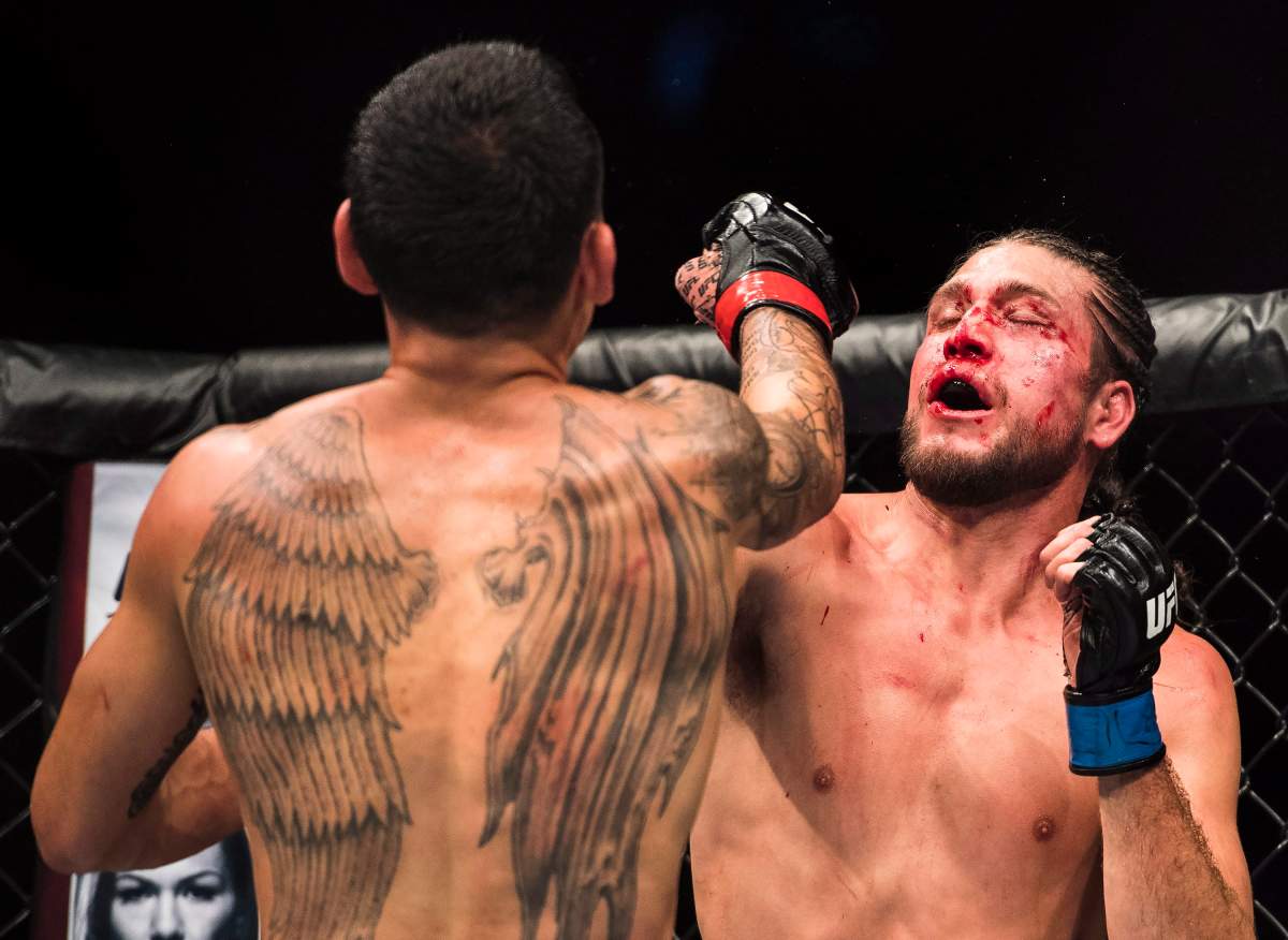 Max Holloway, left, fights Brian Ortega during the UFC Featherweight championship title bout in Toronto on Sunday, Dec. 9, 2018. Holloway won the title fight. THE CANADIAN PRESS/Nathan Denette
