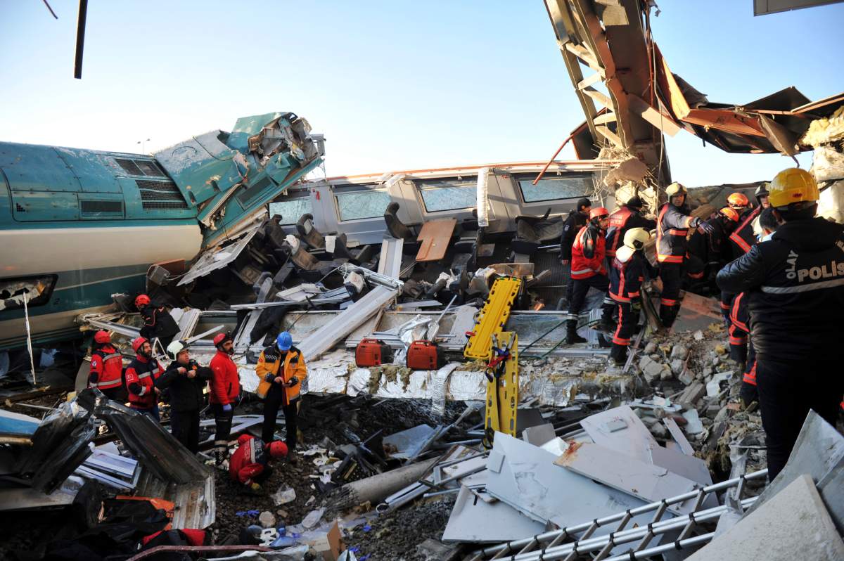 Members of rescue services work at the scene of a train accident in Ankara, Turkey, Thursday, Dec. 13, 2018.