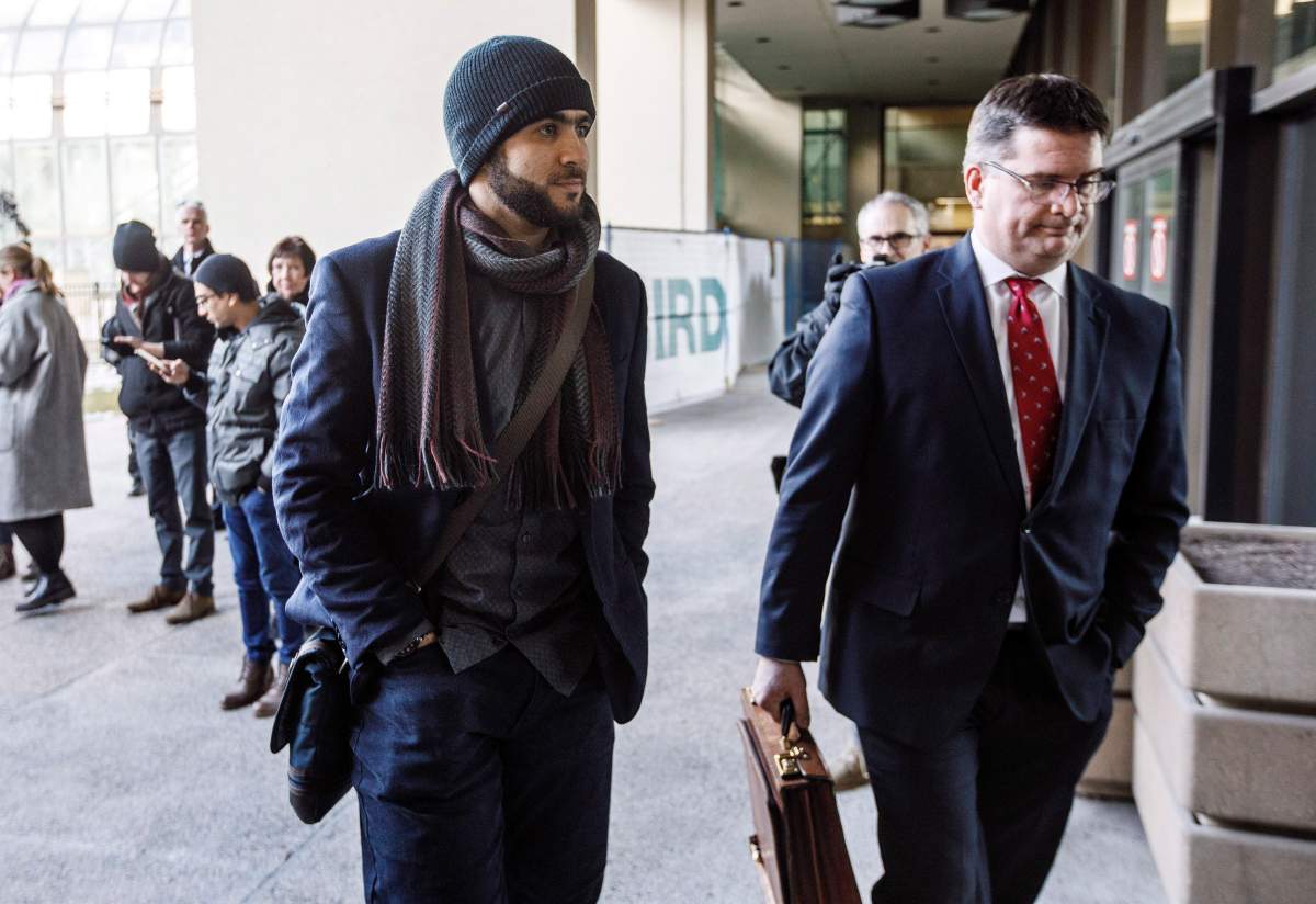 Omar Khadr and his lawyer Nathan Whitling walk into court in Edmonton on Thursday, December 13, 2018. Khadr is seeking a Canadian passport to travel to Saudi Arabia and wants permission to speak to his sister.