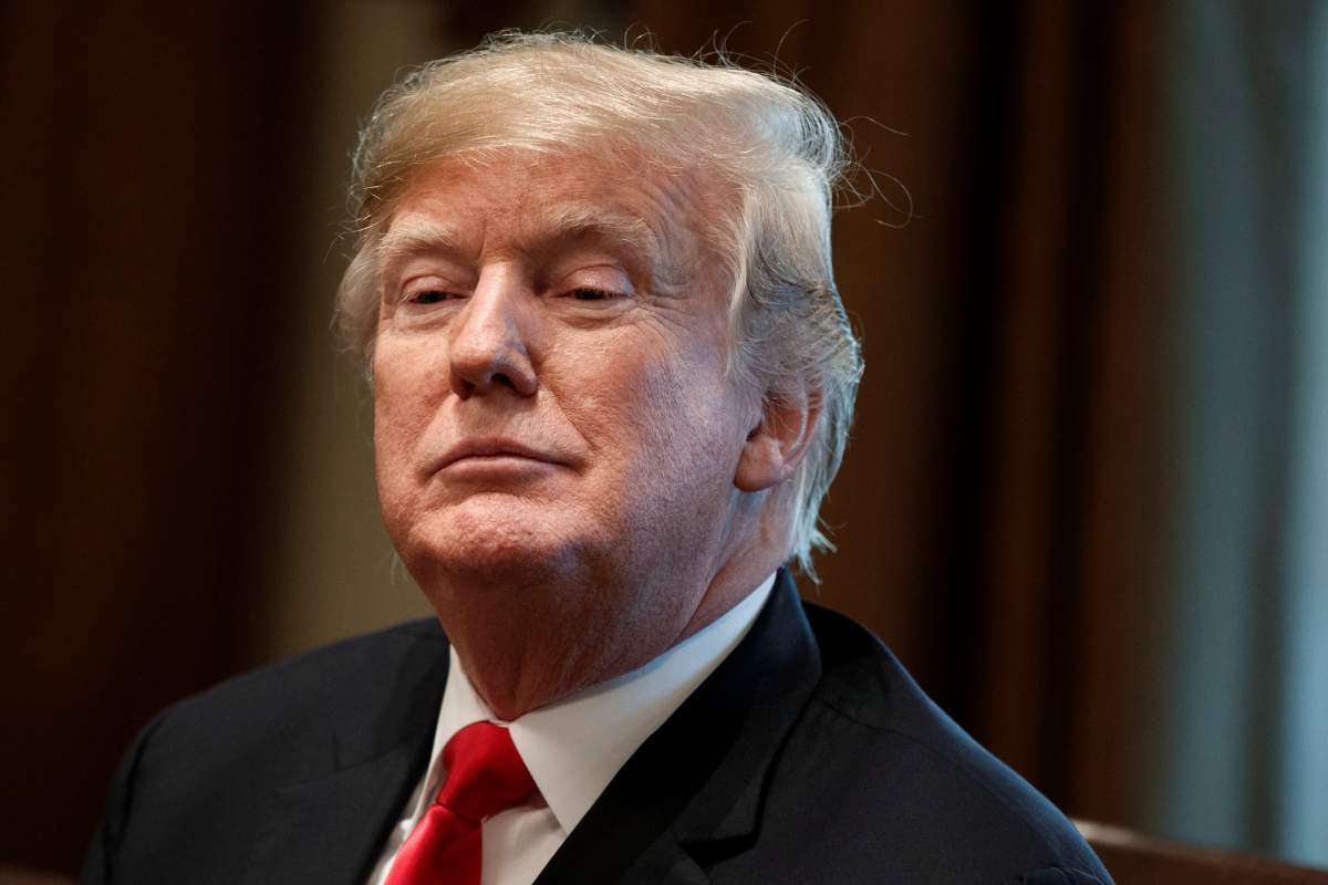 In this Dec. 13, 2018, file photo, President Donald Trump listens during a meeting in the Cabinet Room of the White House in Washington. Trump's charitable foundation has reached a deal to dissolve amid a legal battle with New York's Attorney General Barbara Underwood. 