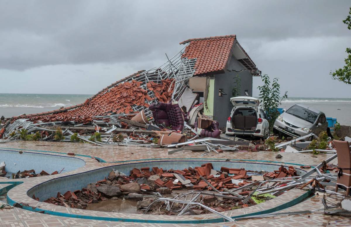 Debris littered a property badly damaged by a tsunami in Carita, Indonesia, Sunday, Dec. 23, 2018.