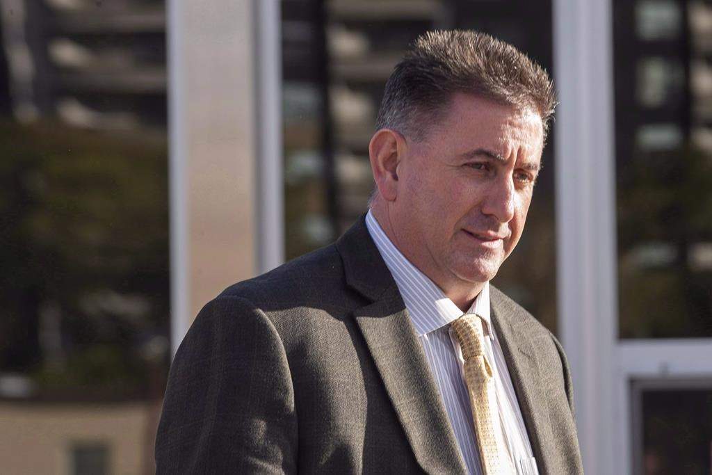 Former gymnastics coach Dave Brubaker, right, leaves the court house in Sarnia, Ont., on October 23, 2018. THE CANADIAN PRESS/Geoff Robins.