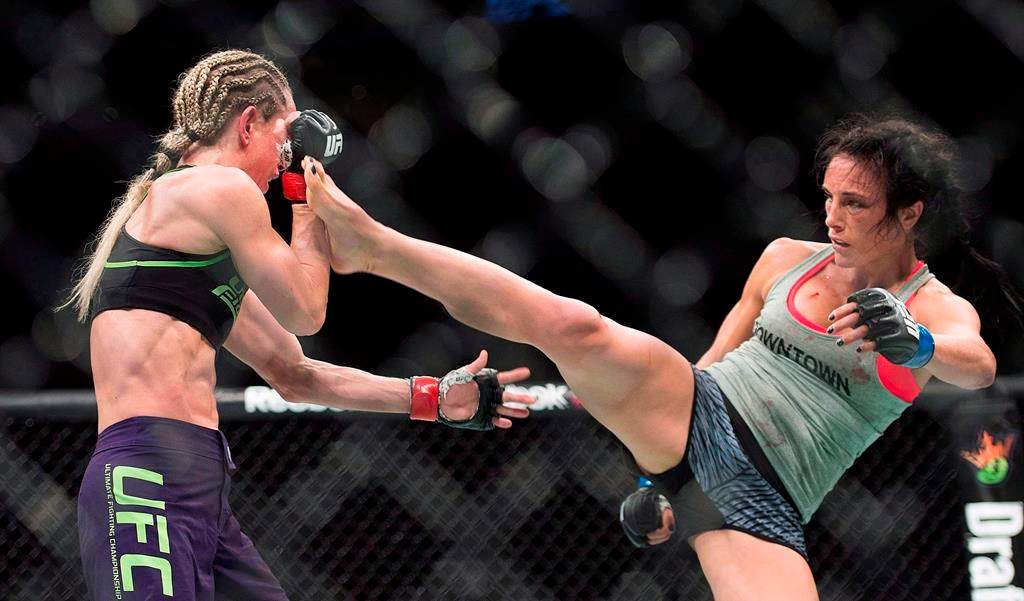 Valerie Letourneau, from Canada, right, lands a kick to the head of Jessica Rakoczy, from Canada, during their UFC 186 fight in Montreal on April 25, 2015. THE CANADIAN PRESS/Graham Hughes.