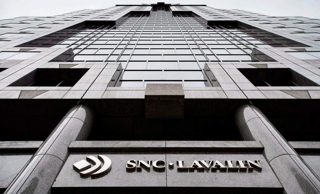 The headquarters of SNC Lavalin is seen Thursday, November 6, 2014 in Montreal. SNC-Lavalin Inc. is eliminating about 100 positions in Canada at the same time as the Quebec engineering firm is being described by political leaders as being vulnerable to a foreign takeover.