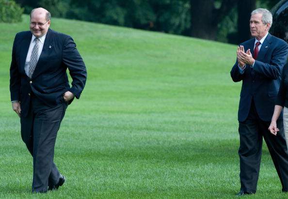 In this July 20, 2008 photo, U.S. President George W. Bush applauds outgoing White House deputy chief of staff Joe Hagin on the South Lawn of the White House.