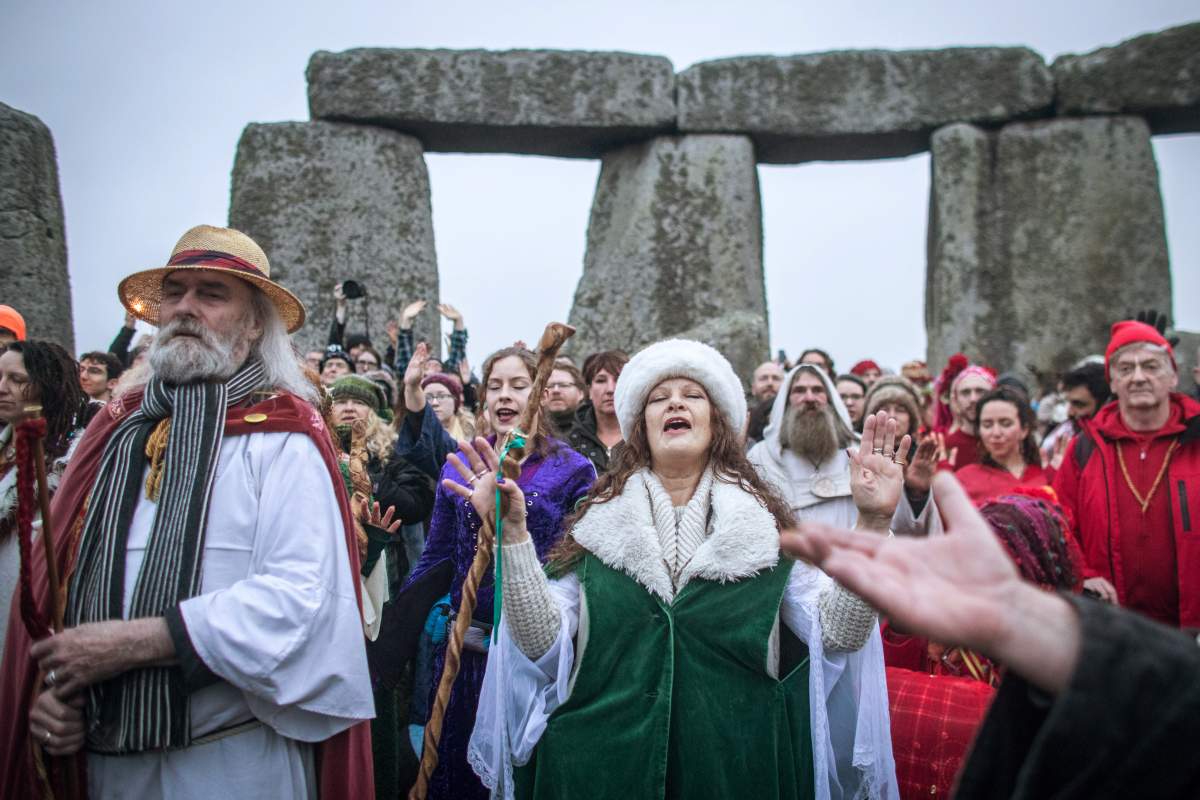 Druids, pagans and revellers gather in the centre of Stonehenge, hoping to see the sunrise, as they take part in a winter solstice ceremony at the ancient neolithic monument of Stonehenge near Amesbury on Dec. 22, 2017, in Wiltshire, England.