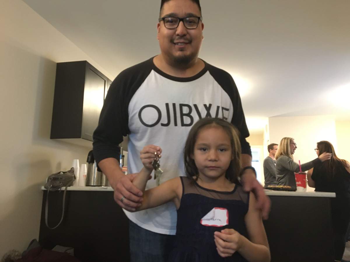 Craig Beaulieu and his daughter Tierra holding the keys to their new house.