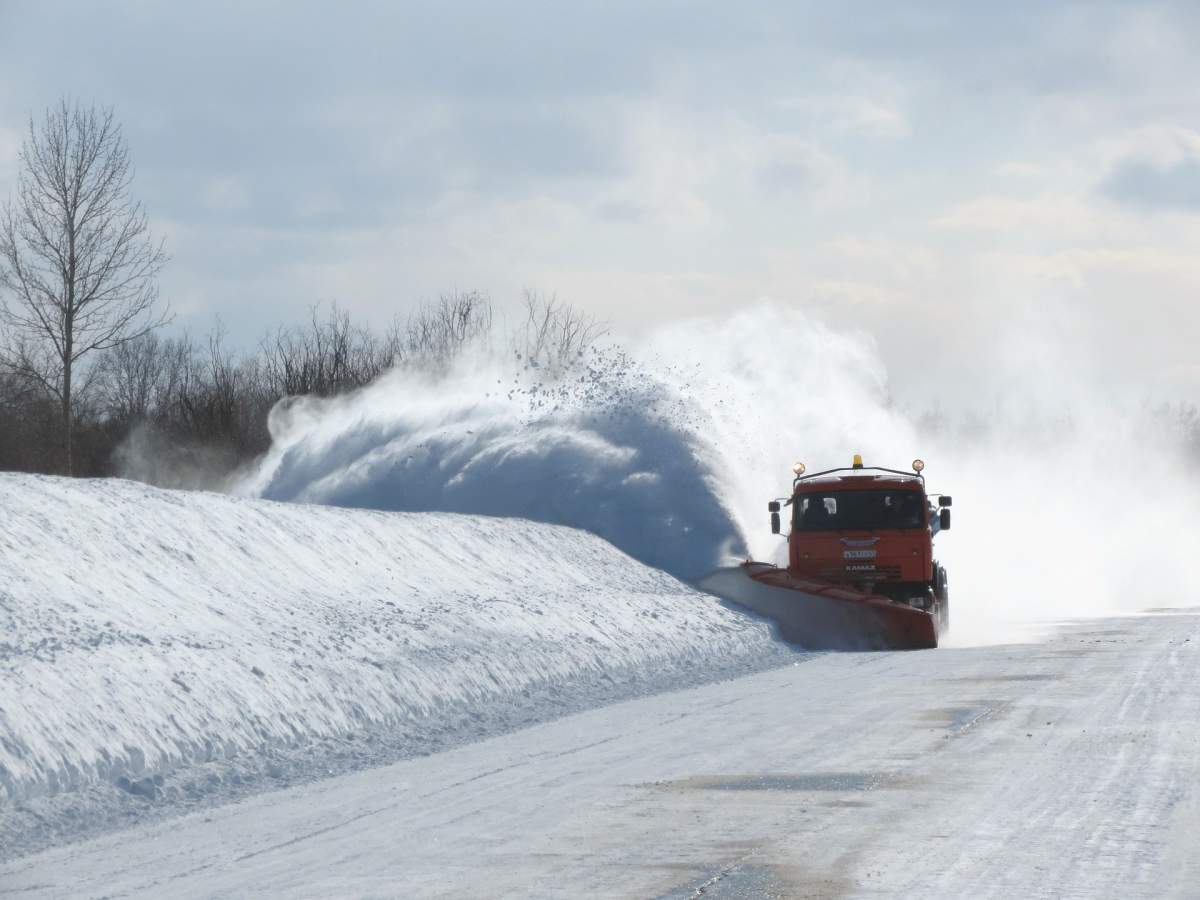 Snow is cleared from a roadway.