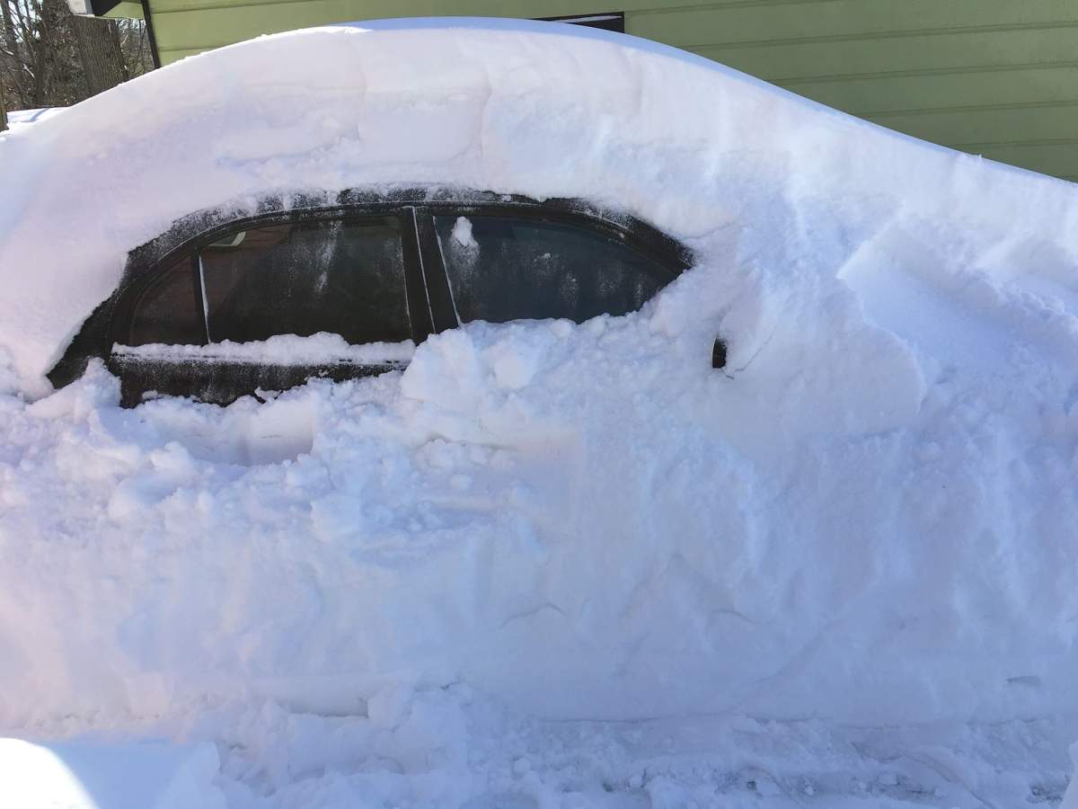 A car is buried in snow.