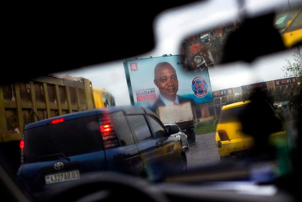 A poster featuring ruling party presidential candidate and former interior minister Emmanuel Ramazani Shadary is displayed on the road leading to the airport in Kinshasa, Democratic Republic of the Congo on Dec. 17, 2018.