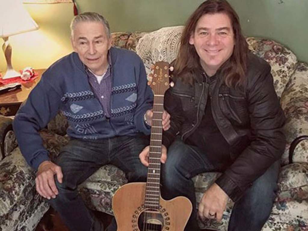 (L-R) Veteran Ed Sheppard and frontman of Great Big Sea, Alan Doyle, pose with a brand new guitar, in 2018.