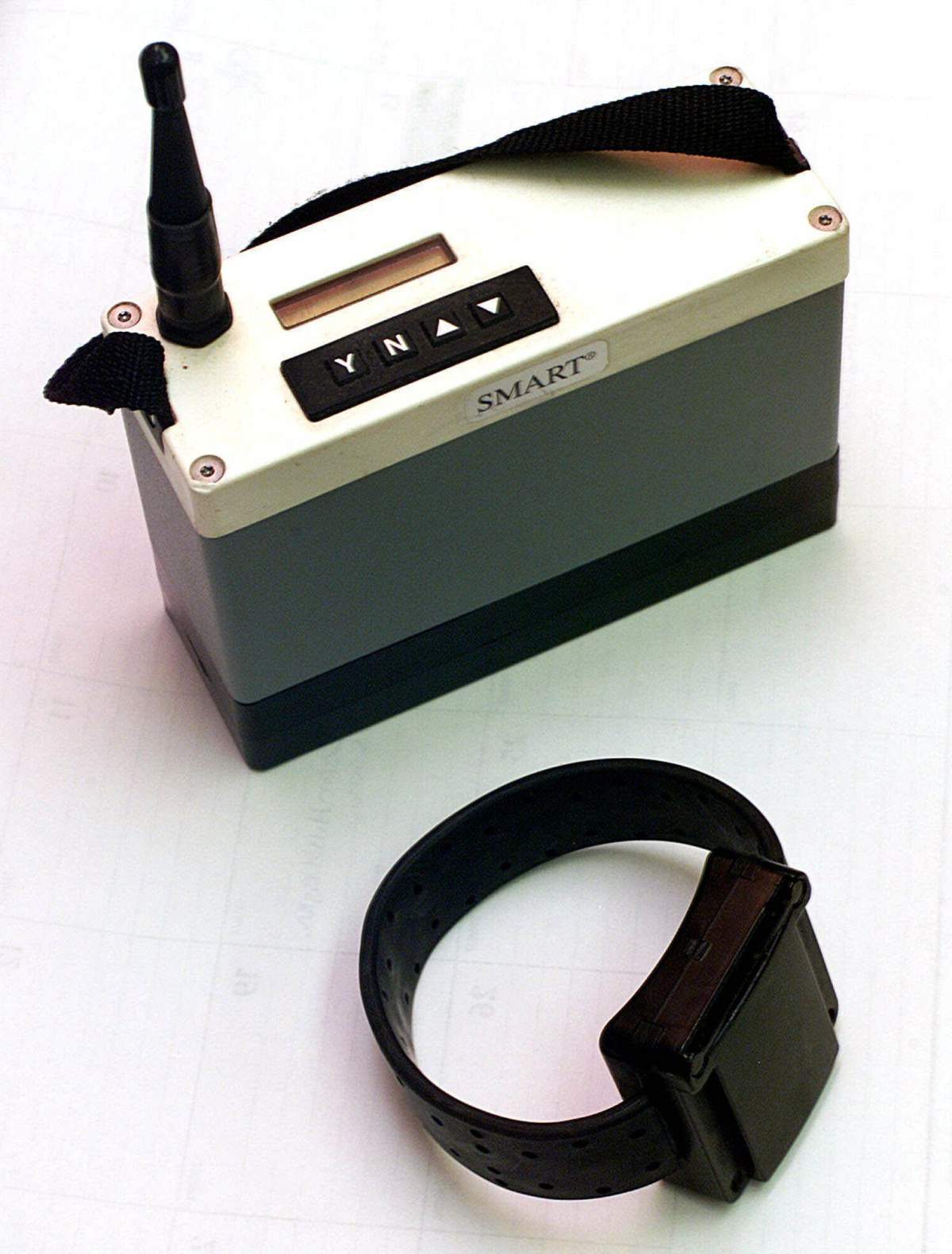 An ankle bracelet and a cellular transmitter box ashwn in this Sept. 10, 2001, photo.