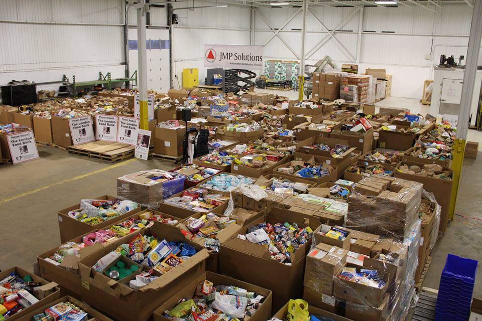 Officials gathered at the JMP Solutions warehouse to wrap up the 2018 Business Cares Food Drive.