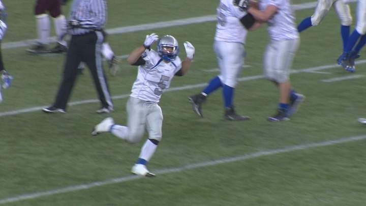 Brady Oliveira celebrates a touchdown with the Oak Park Raiders in 2014.
