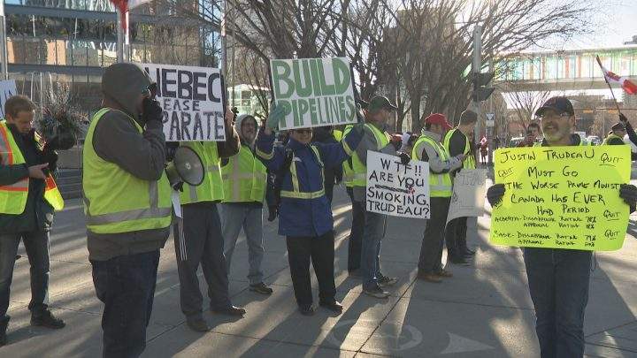 About 100 protesters dressed in yellow safety vests rallied outside Calgary’s city hall on Saturday.