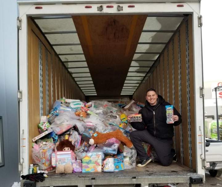Can Man Dan poses infront of truck full of toys to be donated to 630 CHED Santa's Anonymous.