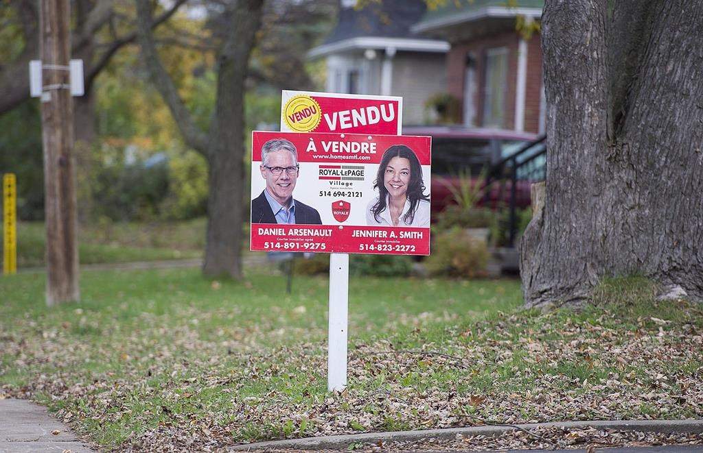 A sign meaning sold is shown on the lawn of a residential property on the west island of Montreal, Saturday, November 4, 2017.