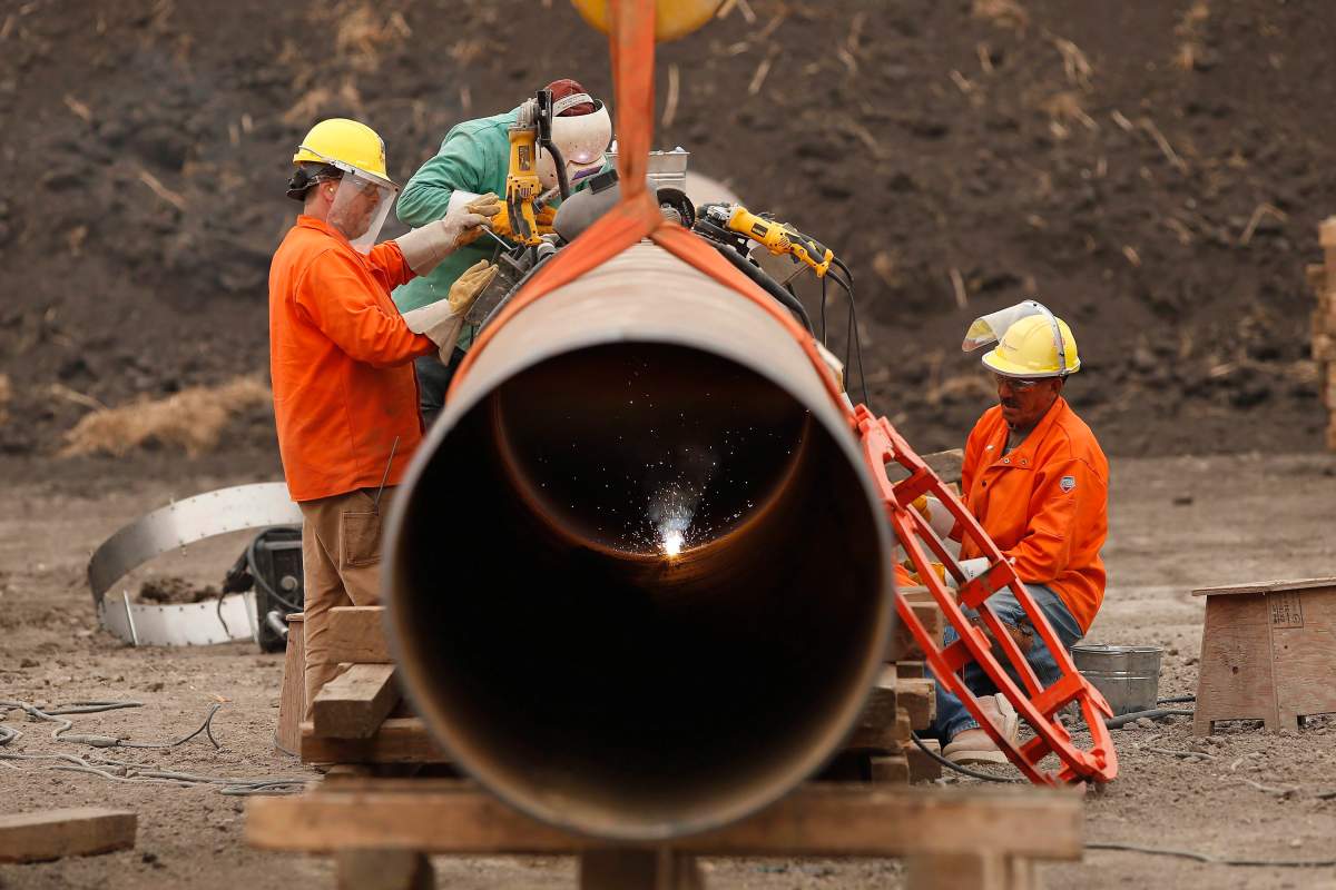 Enbridge workers weld pipe just west of Morden, Man., Thursday, Aug. 16, 2018. A press conference and tour of a Line 3 site for federal, provincial, municipal and indigenous leaders was held at the site.