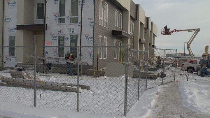 Multi-family housing construction going up in Calgary's SE during Alberta's downturn.