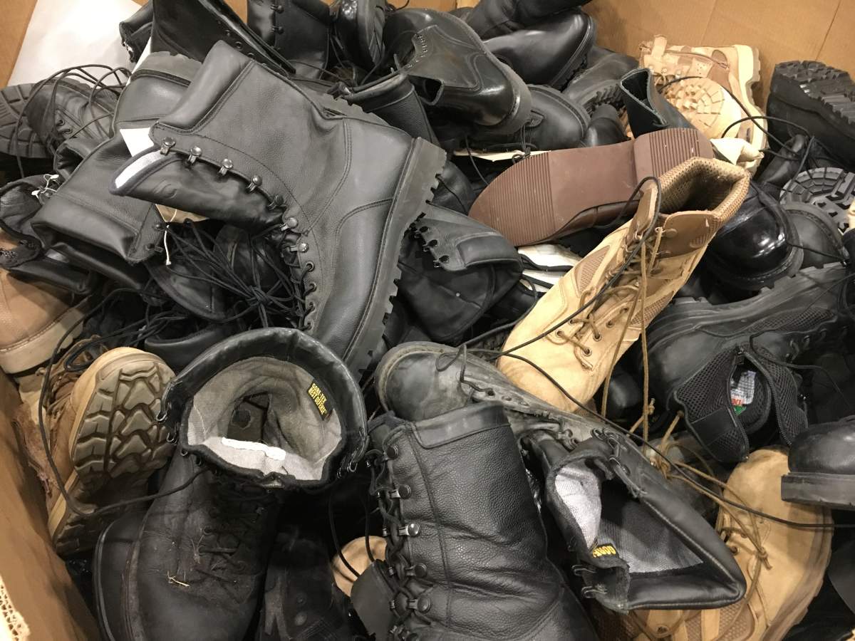 A bin of used military boots being sold by the government on www.gcsurplus.ca