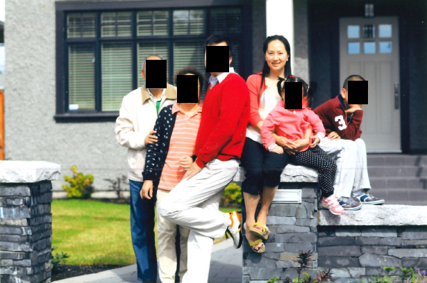 Meng Wanzhou with family in front of a home in Vancouver.