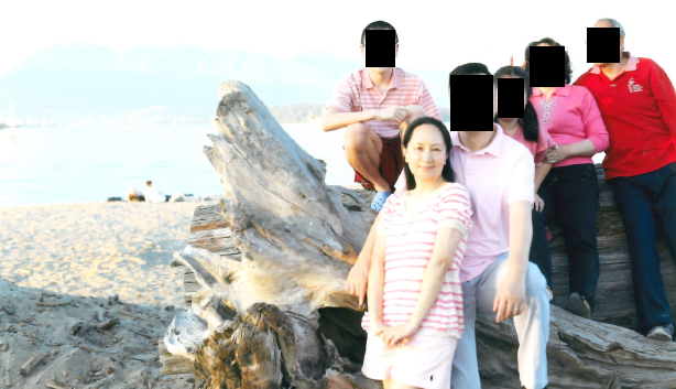 Meng Wanzhou with family on a beach.