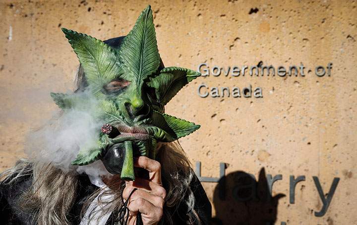 Cannabis supporter Heather Pratt lights up at a rally outside governments offices following the legalization of cannabis in Calgary, Alta., Wednesday, Oct. 17, 2018.