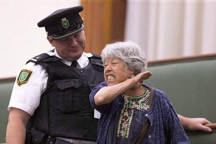 A protester in the public gallery shouts at MPPs during Question Period at the Ontario Legislature in Toronto on Wednesday September 12, 2018.