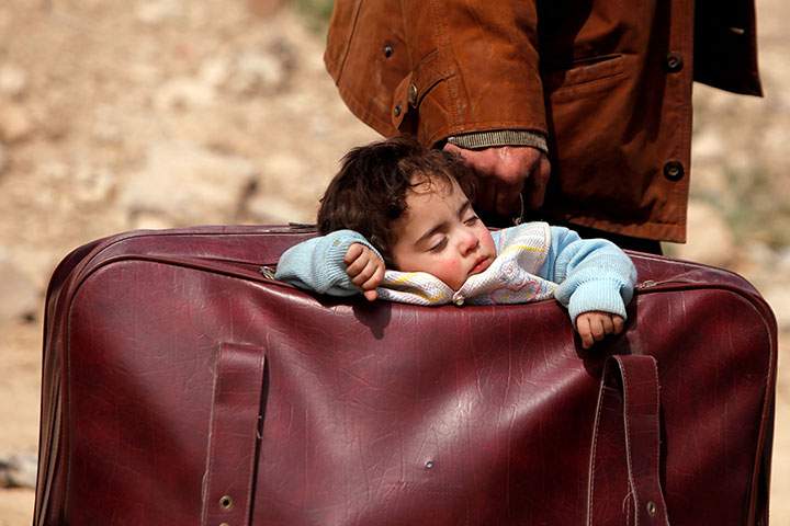 A child sleeps in a bag in eastern Ghouta, Syria, March 15, 2018.