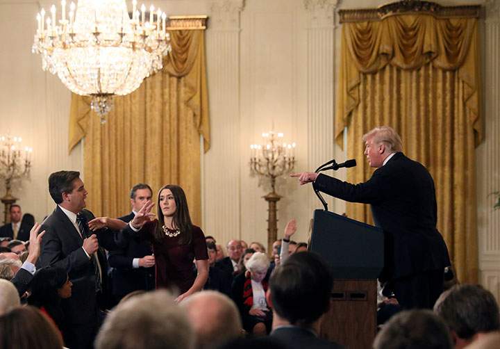 A White House staff member reaches for the microphone held by CNN’s Jim Acosta as he questions U.S. President Donald Trump during a news conference following midterm U.S. congressional elections, at the White House in Washington, November 7, 2018.