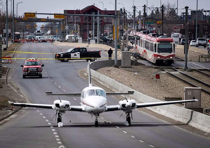 A twin-engine plane sits in an area taped-off by police on 36th Street NE in Calgary on Wednesday, April 25, 2018.