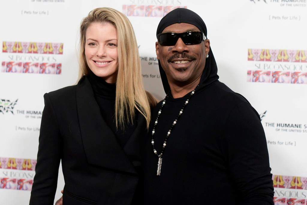 Paige Butcher, left, and Eddie Murphy attend "SUBCONSCIOUS" by Bria Murphy Gallery Opening at Lace Gallery in Los Angeles.