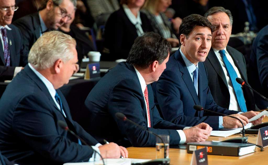 Prime Minister Justin Trudeau addresses the first session of the first ministers meeting flanked by Ontario Premier Doug Ford, intergovernmental Affairs Minister Dominic LeBlanc and Quebec Premier Francois Legault in Montreal on Friday, December 7, 2018.