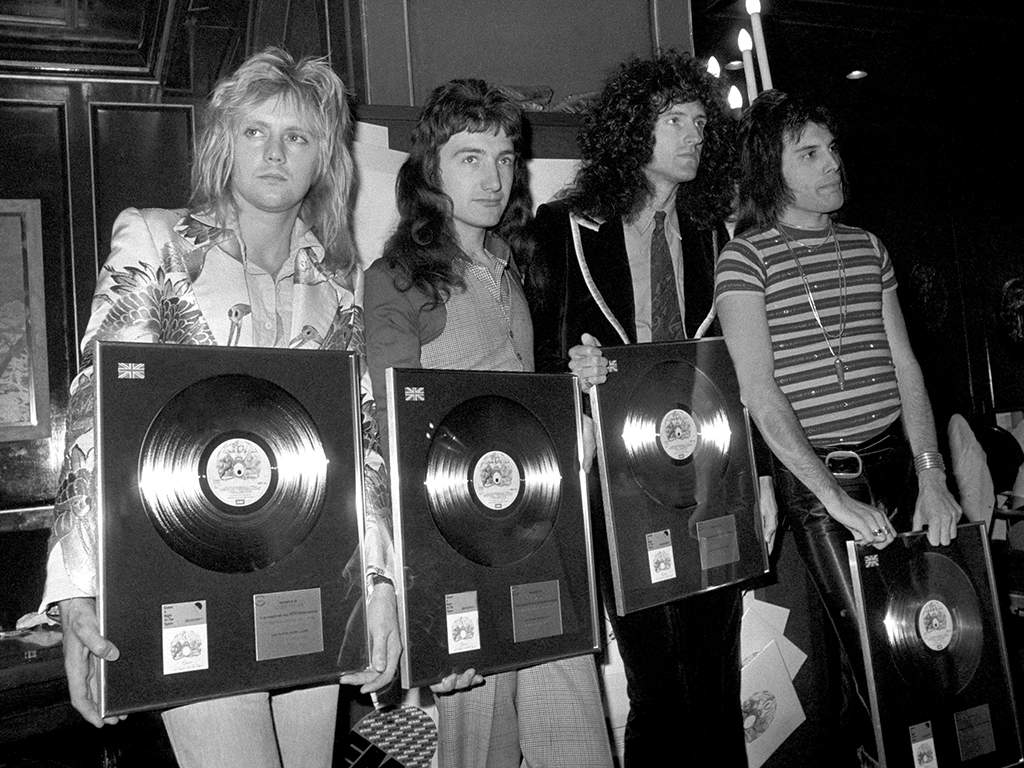 (L-R) Roger Taylor, John Deacon, Brian May and Freddie Mercury, with awards they received for the sales of ‘Bohemian Rhapsody.’