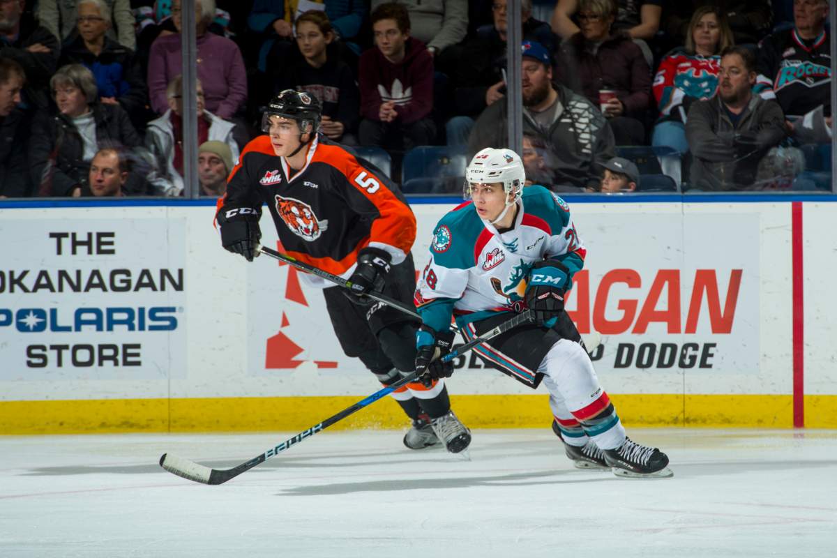 Kristians Rubins #5 of the Medicine Hat Tigers back checks Leif Mattson #28 of the Kelowna Rockets on January 30, 2017 at Prospera Place in Kelowna, British Columbia.