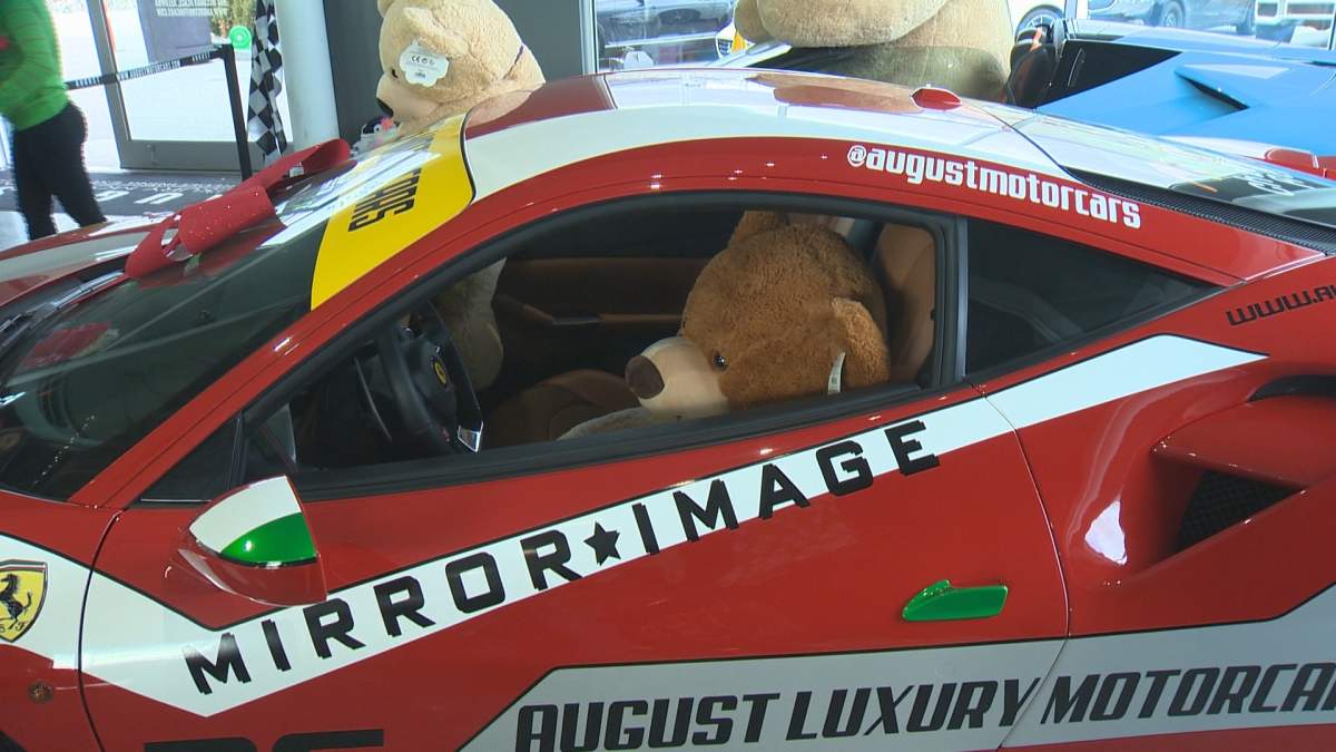 Santa posed with kids and sports cars for a good cause on Sunday.