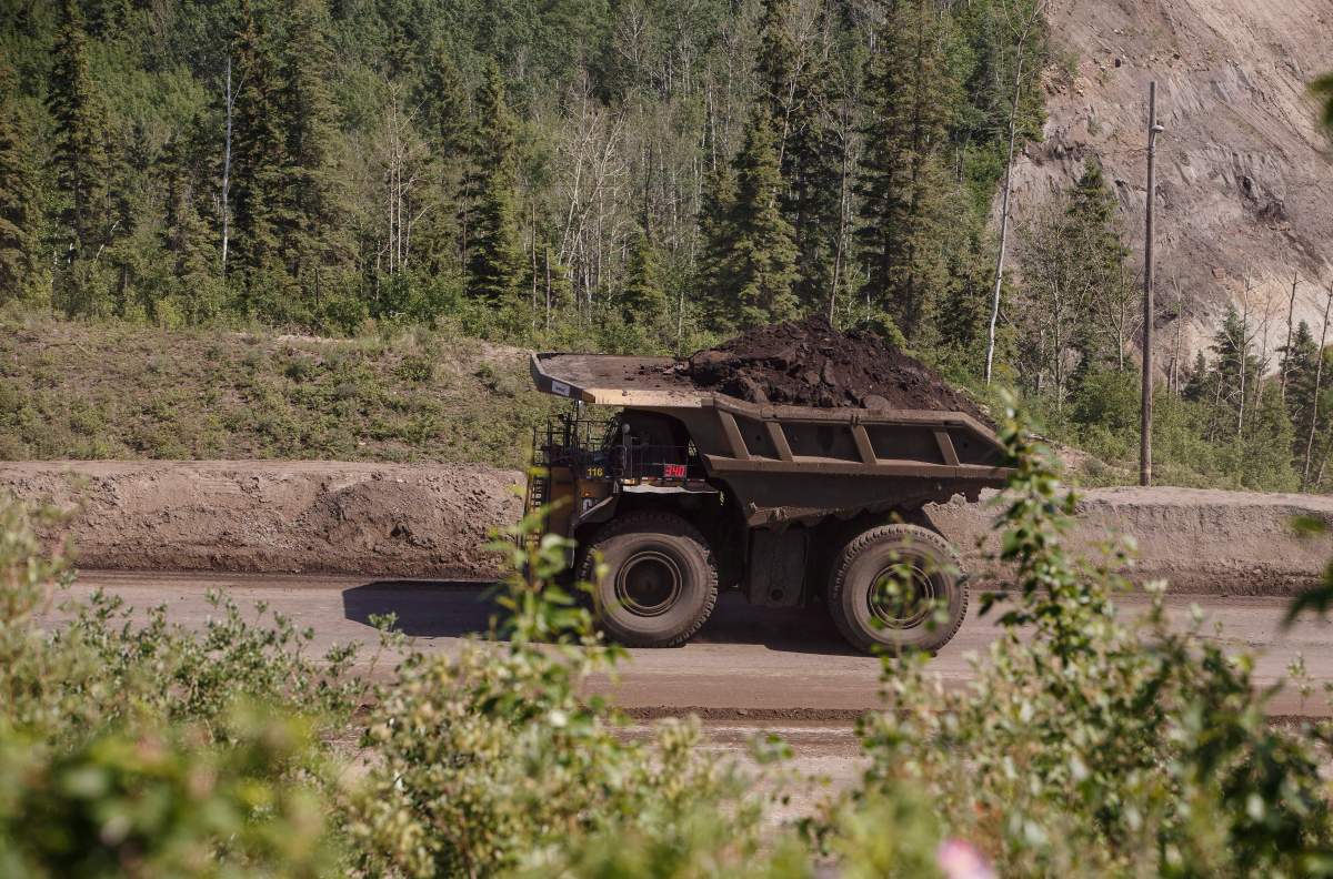 A heavy hauler truck transports material from Suncor’s North Steepbank in the oil sands in Fort McMurray Alta, on Monday June 13, 2017.