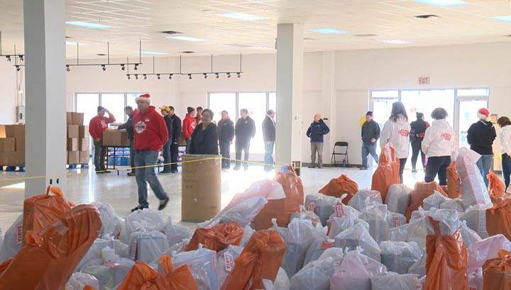 At Secret Santa Foundation’s hamper distribution day, less fortunate families in Saskatoon received gifts filled with toys, books and nutritious food.