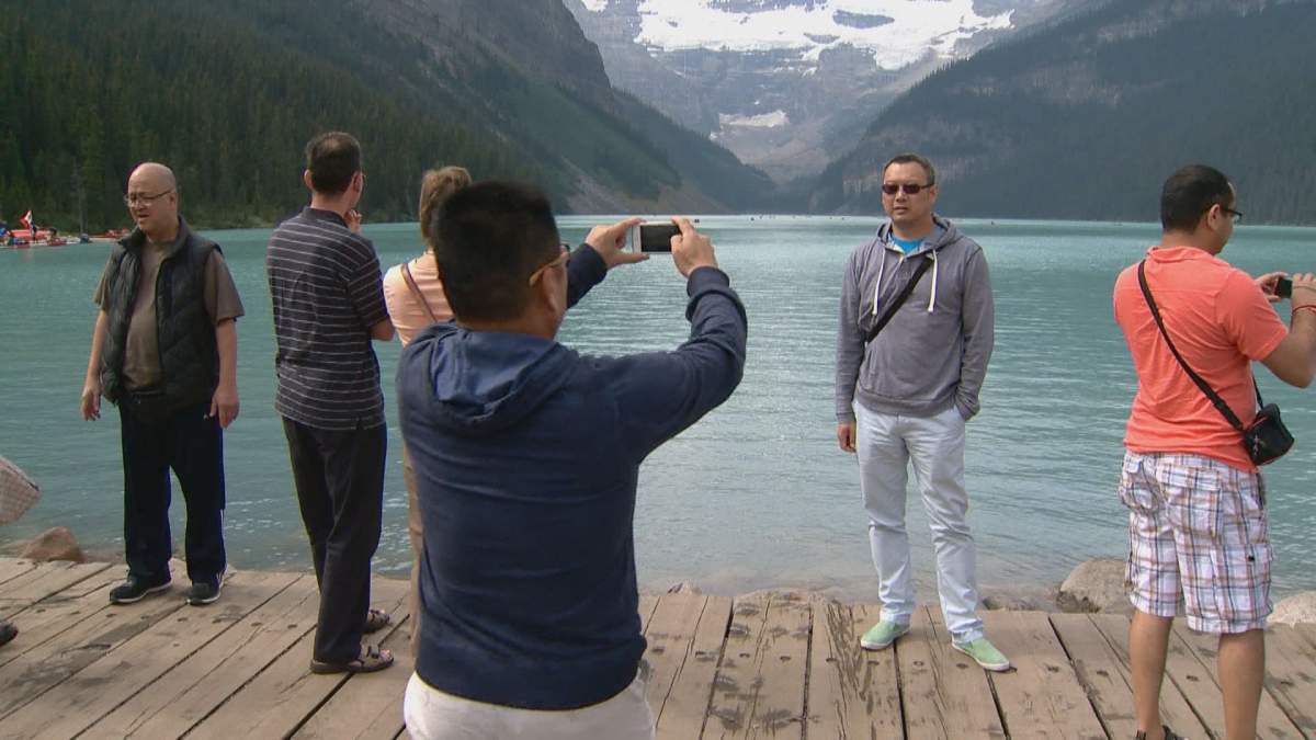 Tourists snap a photo at Lake Louise in Banff National Park.