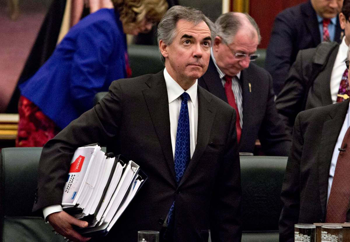 Alberta Premier Jim Prentice carries the budget after Alberta Finance Minister Robin Campbell delivered the 2015 budget in Edmonton, Alta., on Thursday, March 26, 2015.