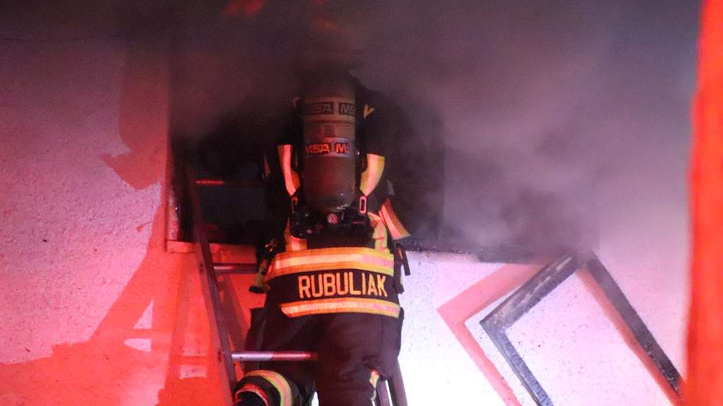 Surrey crews work to knock down a fire in a duplex in Whalley on Thursday.