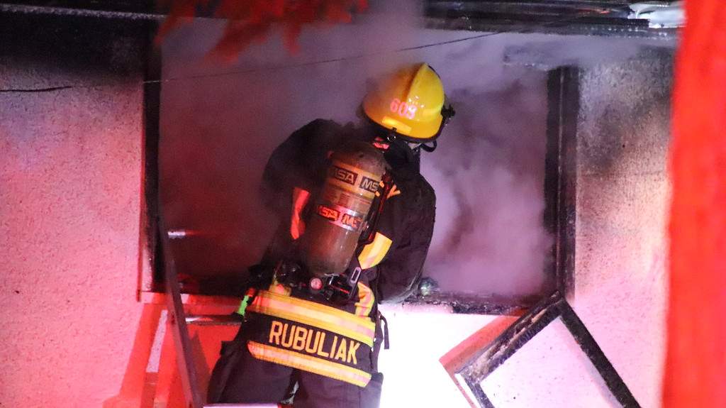 Surrey crews work to knock down a fire in a duplex in Whalley on Thursday.